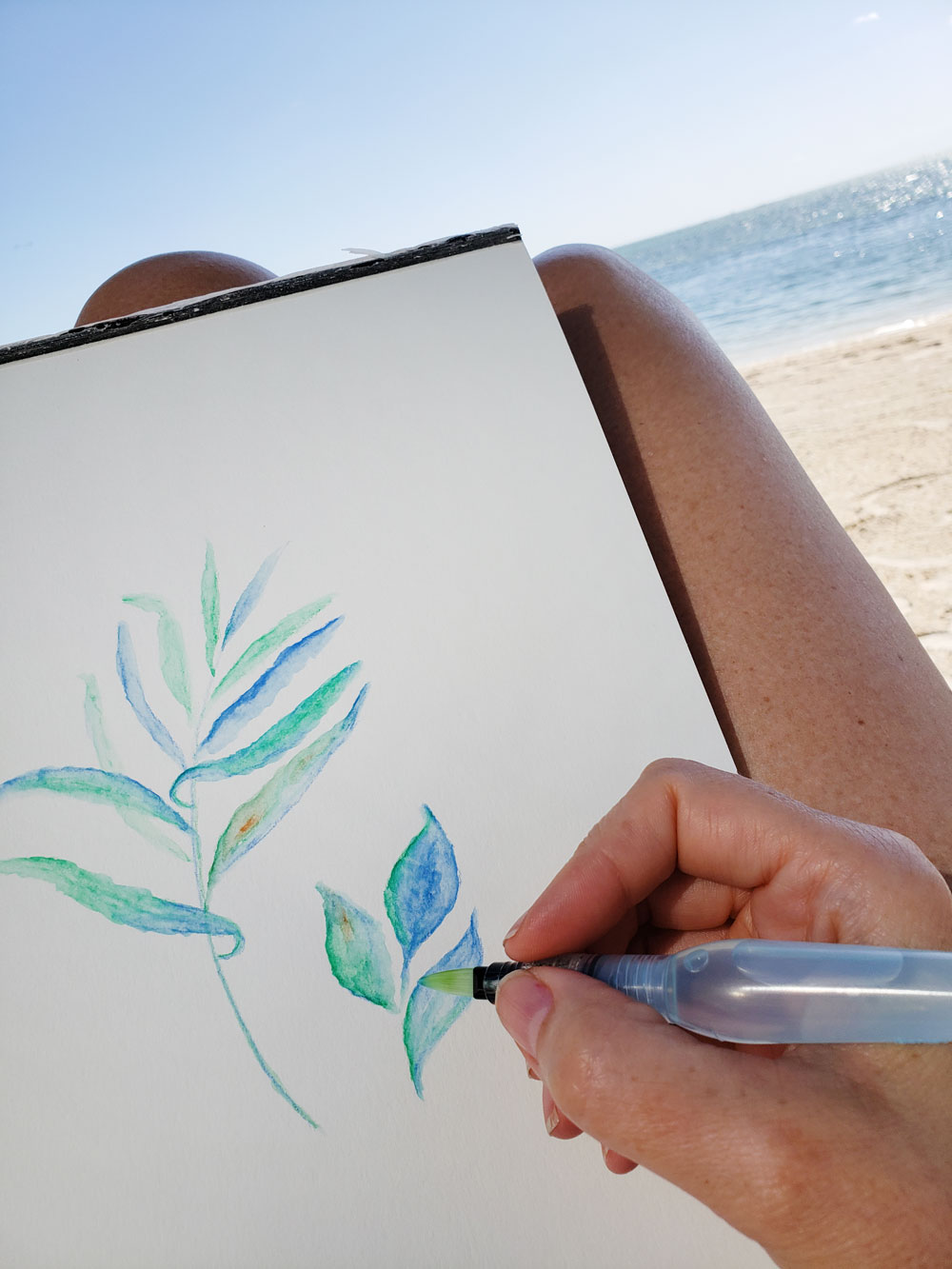 Painting watercolor art on the beach at the Postcard Inn and Resort in Islamorada