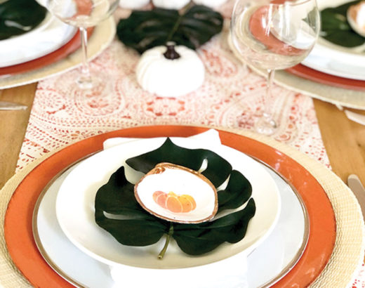 place setting with white pumpkin Palm Beach Thanksgiving tablescape with and monstera leaves